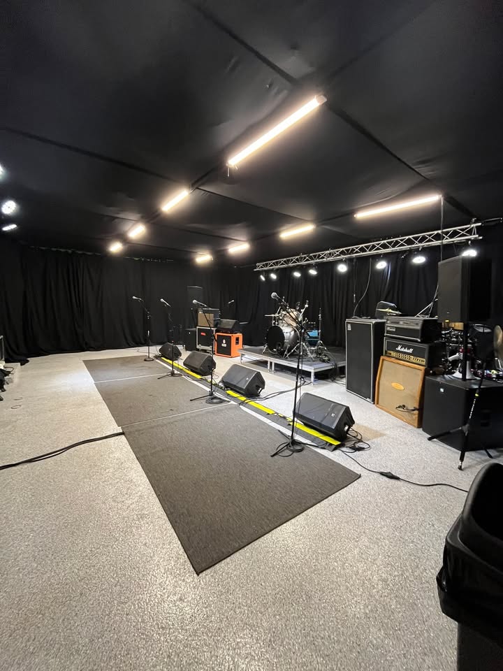 Stage truss with rehearsal lighting and full backline