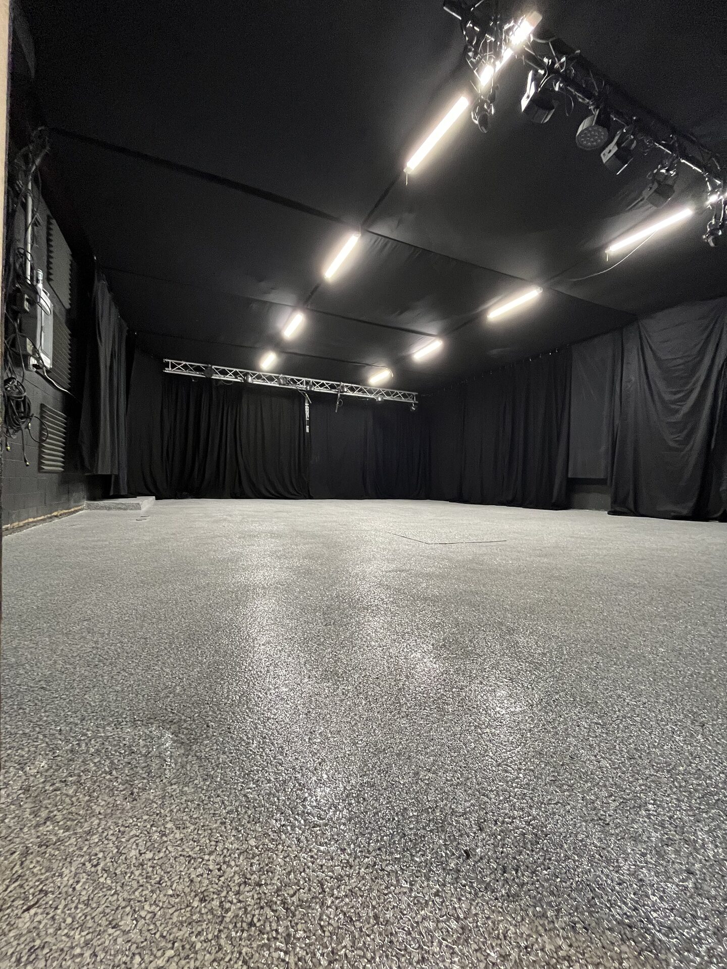 Side view of the bare Rock Mill rehearsal room with stage area cleared